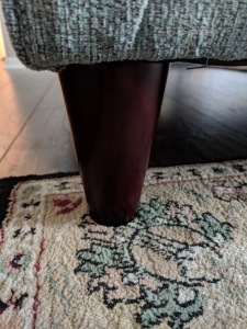 couch leg on the corner of a rug